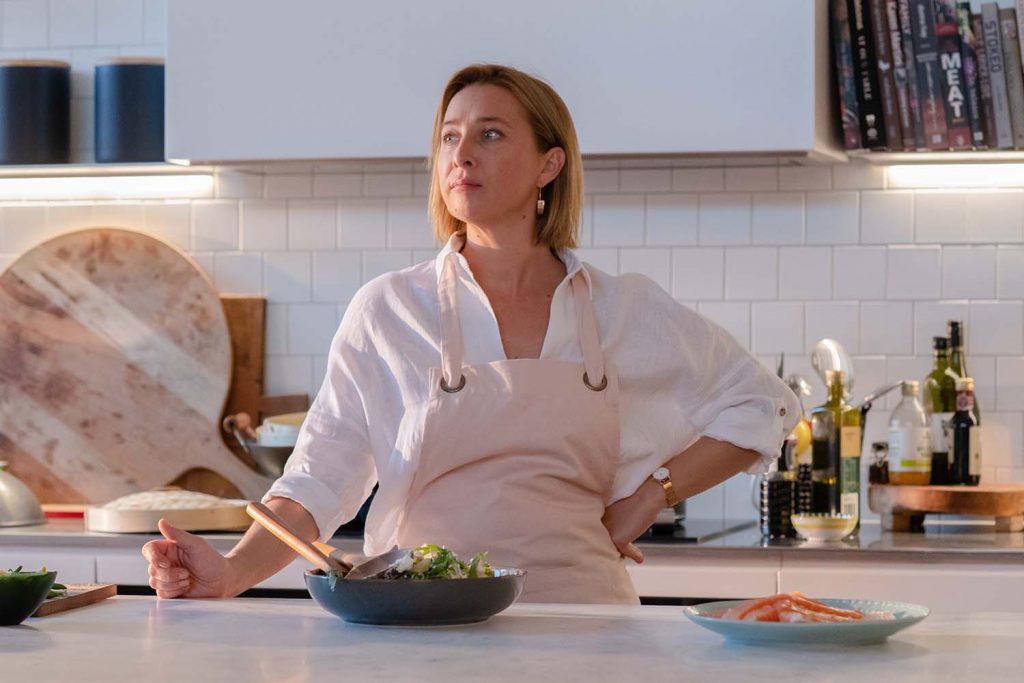 Asher Keddie stands in the grand open-plan kitchen in an old-money Adelaide house, discussing her character’s motivation.